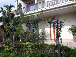 a house with a bunch of plants in front of it at An Phu's Garden House in Ninh Binh