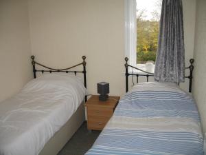 two twin beds in a bedroom with a window at Newton Brewery Inn in Middlewich