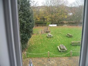 a view from a window of a park with picnic tables at Newton Brewery Inn in Middlewich