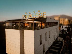 a building with a sign on top of it at Privilege Hotel & Spa in Tirana