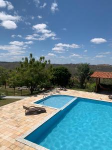 a swimming pool with a view of a house at Casa Schneider in Gravatá