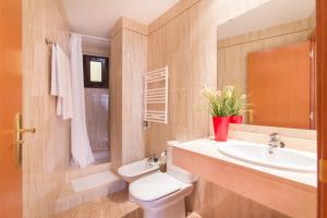 a bathroom with a white toilet and a sink at Sweet Apartments in Sant Pere de Ribes +38 photos
