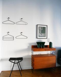 a room with a wooden dresser and a chair at L’Appartement des Glières Annecy centre in Annecy