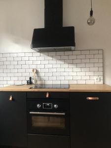 a kitchen with a sink and a stove at L’Appartement des Glières Annecy centre in Annecy