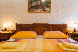a bedroom with a bed with two yellow pillows at Apartment Ledrar in Bled