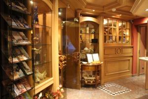 a room with a book store with a desk in it at Hôtel Le Mittelwihr in Mittelwihr