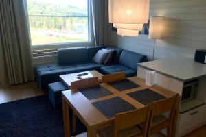 a living room with a couch and a table at Tahko Chalet B 601 in Tahkovuori