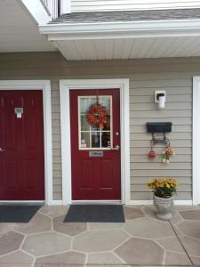 a house with two red doors and a window at Affordable Suites Florence in Florence