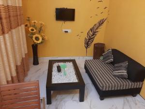a living room with a couch and a table at Holiday home Bouncer's Place in Hikkaduwa