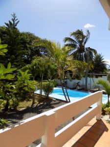 a view of the pool from the balcony of a resort at Villa Osumare Guest House in Flic-en-Flac
