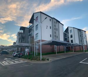 a building with a clock on it in a parking lot at Canvas Luxury Apartments in Johannesburg