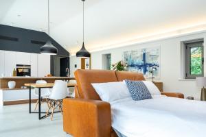 a bedroom with a bed and a dining room at The Barn : Luxury Indoor/Outdoor Countryside Bliss in Clipston