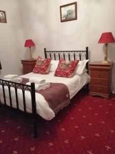 a bedroom with a large bed with red pillows at Crown Spa Apartment 13 in Scarborough