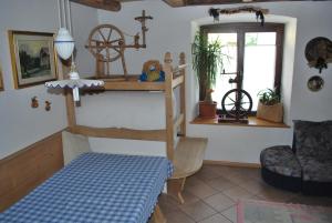 a room with a bed and a shelf and a window at Appartamento Casa Delmarco in Castello di Fiemme