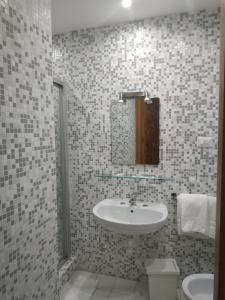 a bathroom with a sink and a mirror at Hotel Luna Rossa in Naples