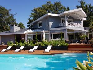 a house with a swimming pool in front of a house at Villa Gayac in Gradignan