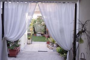a hallway with white curtains and potted plants at B&B dai Carari in Mira
