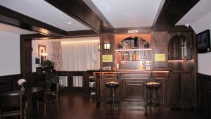 a bar in a restaurant with stools at Villa Elitte Predeal in Predeal
