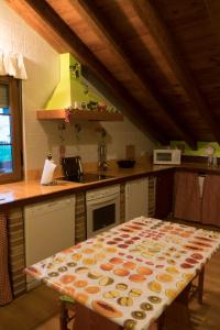 a kitchen with a table with a pattern on it at Apartamentos Carmen de Castro in Comillas