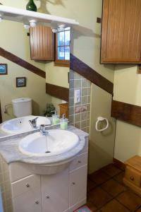 a bathroom with a sink and a mirror at Apartamentos Carmen de Castro in Comillas