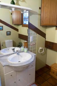 a bathroom with a sink and a mirror at Apartamentos Carmen de Castro in Comillas +37 photos