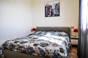 a bedroom with a bed and a picture on the wall at Bilocale in campagna - Assisi in Assisi