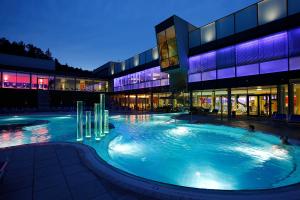 a large swimming pool in a building at night at Ferienwohnungen Fam. Pabst in Maria Lankowitz