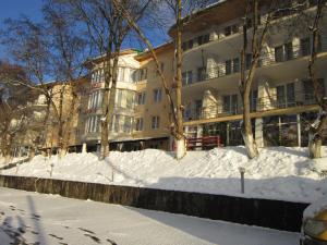 a snow covered street in front of a building at Готель Поляна Квеле in Polyana