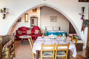 a living room with a table and a couch at Koilon Apartments in Mochlos