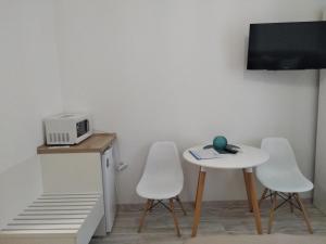 a room with a table and two chairs and a microwave at Kharkov & Apartments in the city center in Kharkiv