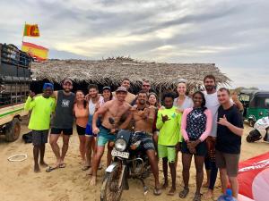 a group of people posing for a picture on the beach at Margarita Village kite school kalpitiya in Kalpitiya