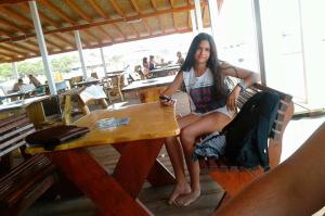 a woman is sitting at a table at a table at 500 Meters from Grate Beach, App 10 in Ulcinj +16 photos