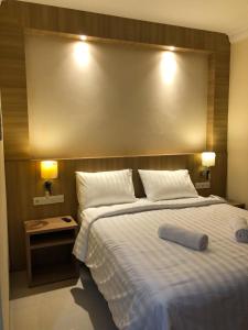 a bedroom with a large bed with a large headboard at LCR HOTEL in Ende