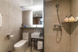 a small bathroom with a toilet and a shower at Hotel Seattle Incheon Airport in Incheon