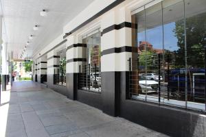 a building with black and white stripes on the side at Royal Hotel Orange in Orange
