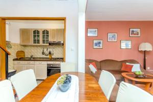 a kitchen and a living room with a table and a couch at Apartment Buksa in Trogir