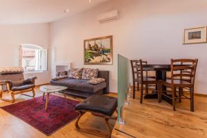 a living room with a couch and a table at Apartments Calma in Cres