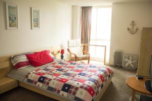a bedroom with a bed with a quilt on it at Bargain Condo in Beach Resort A-206 in Oceanside