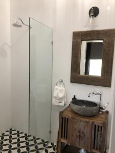 
a bathroom with a shower, sink, and mirror at Palmyra B&B in Rainbow Flat
