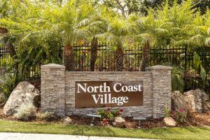 a sign for a north coast village in front of a fence at Bargain Condo in Beach Resort A-206 in Oceanside