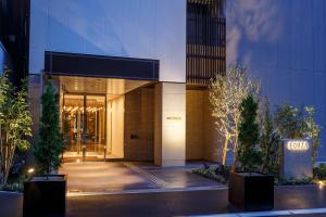 a building with a sign in front of it at Hotel Forza Osaka Kitahama in Osaka