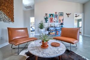 a living room with two chairs and a table at Eclectic Joshua Tree in Joshua Tree
