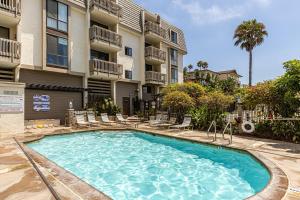 a swimming pool in front of a apartment building at Bargain Condo in Beach Resort A-206 in Oceanside