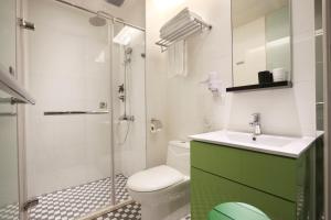 a bathroom with a toilet, sink, and shower at CityInn Hotel Plus - Taichung Station Branch in Taichung