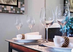 a table with wine glasses and plates on it at Modern Place of Style in Manila