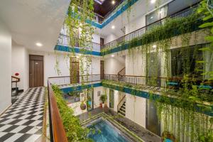 an indoor pool in a building with plants on the walls at The Nam An Villa Hoi An in Hoi An