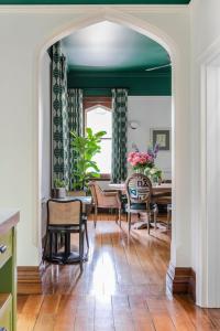 a living room with a green ceiling and a table and chairs at Byng Street Boutique Hotel in Orange