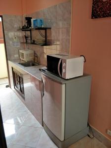 a microwave sitting on top of a counter in a kitchen at Thalassa in Nai Harn Beach