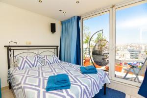 a bedroom with a bed and a large window at Kalypso Apartment in Athens