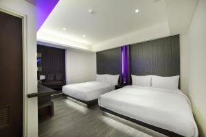 Letto o letti in una camera di Seven Fukun Hotel